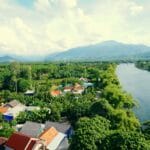 Z lotu ptaka spokojna dolina rzeki wśród zieleni i rozrzuconych domów