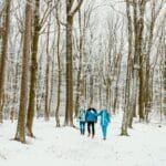 Grupa przyjaciół na zimowym spacerze po zaśnieżonym lesie Doliny Dunajca